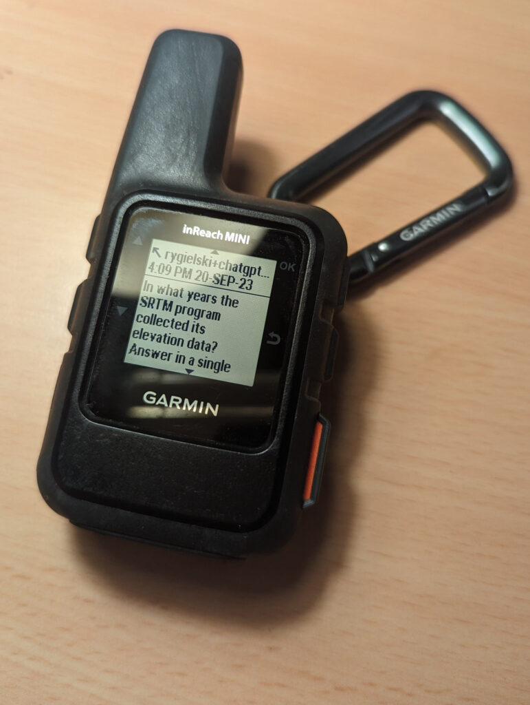 A photo of a Garmin InReach device with a visible ChatGPT conversation.
